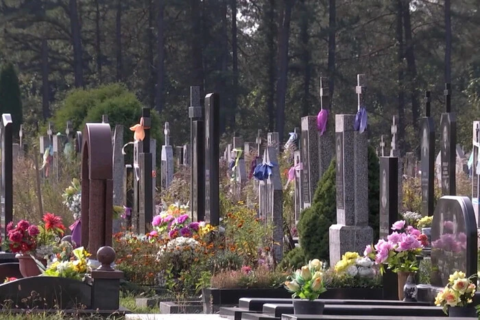Child painting with lipstick on graves